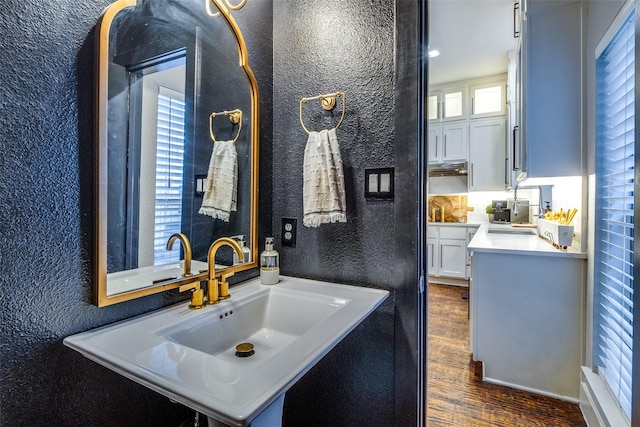 bathroom with tasteful backsplash, vanity, and wood-type flooring