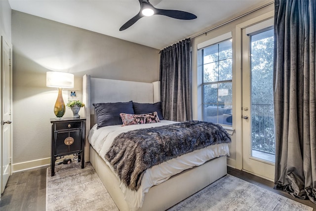 bedroom with hardwood / wood-style floors, access to outside, and ceiling fan