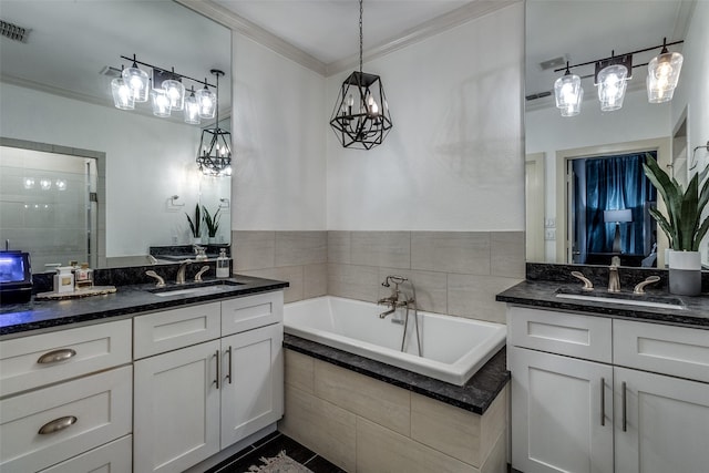 bathroom with vanity and tiled bath