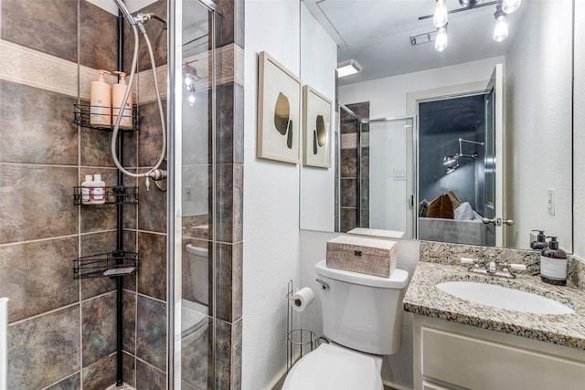 bathroom with vanity, toilet, and walk in shower