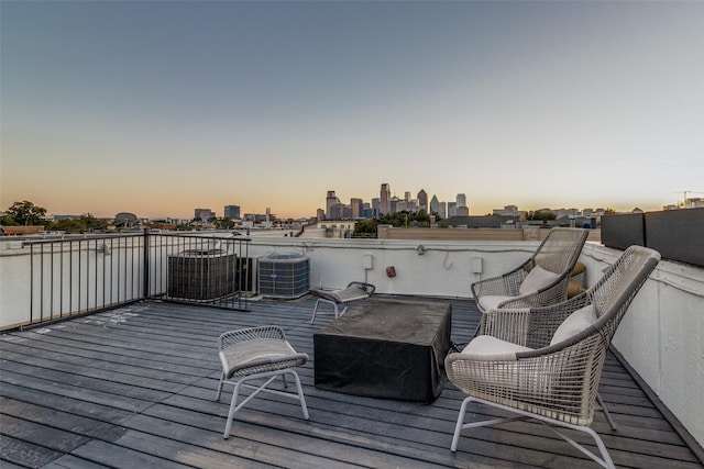 deck at dusk featuring central AC unit