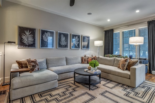 living room featuring light wood-type flooring and crown molding