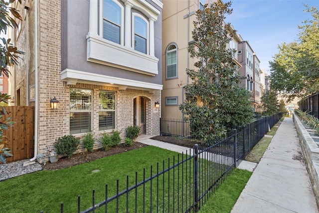 view of exterior entry with a lawn