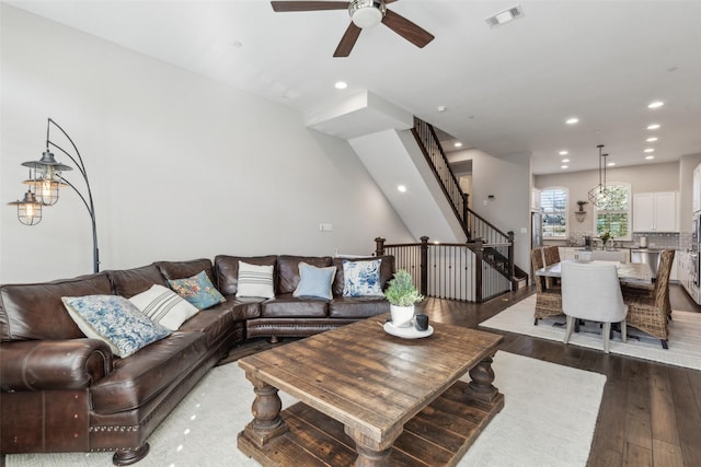 living room with dark hardwood / wood-style floors and ceiling fan