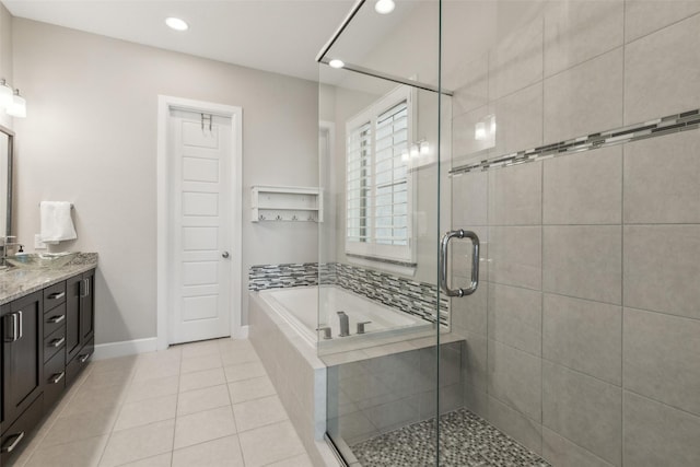 bathroom with plus walk in shower, tile patterned flooring, and vanity