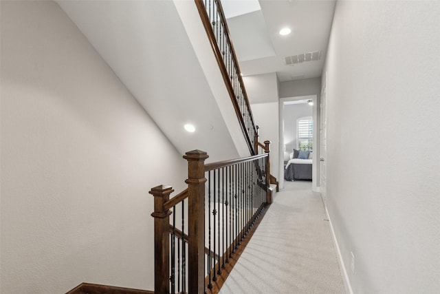 hallway featuring light carpet