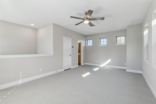 unfurnished room with ceiling fan and light colored carpet