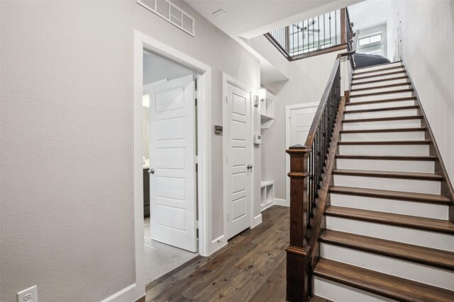 staircase with hardwood / wood-style floors