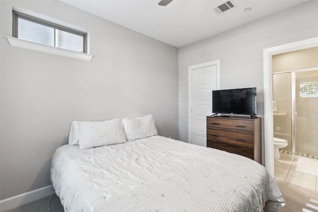 bedroom featuring tile patterned flooring, ceiling fan, and ensuite bath