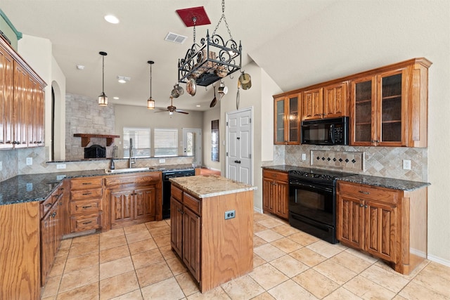 kitchen with a center island, black appliances, sink, ceiling fan, and decorative backsplash