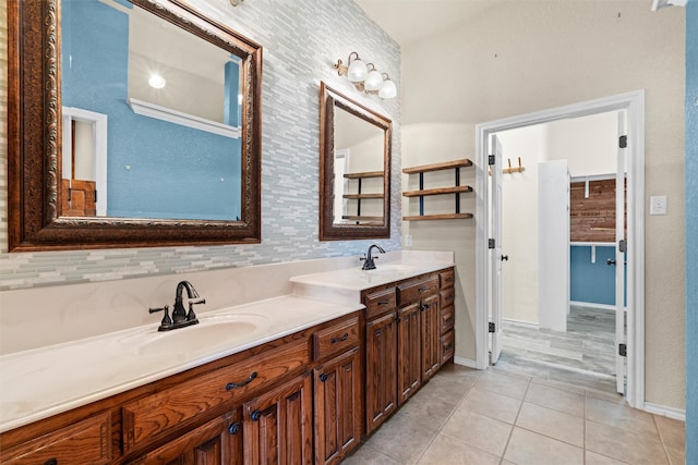 bathroom with tile patterned floors, tasteful backsplash, and vanity