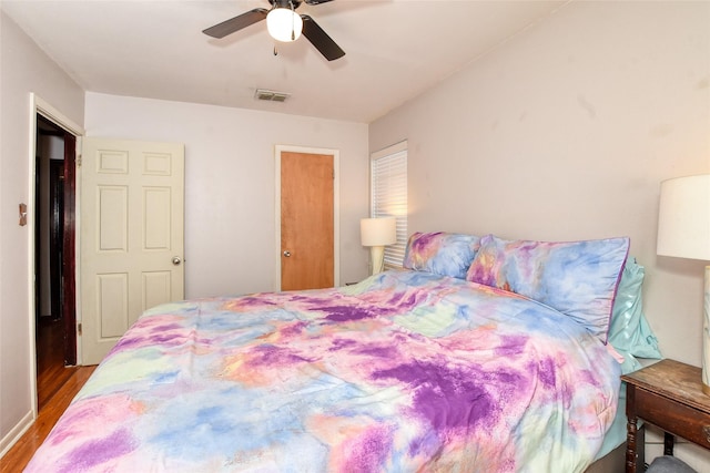 bedroom with ceiling fan and wood-type flooring