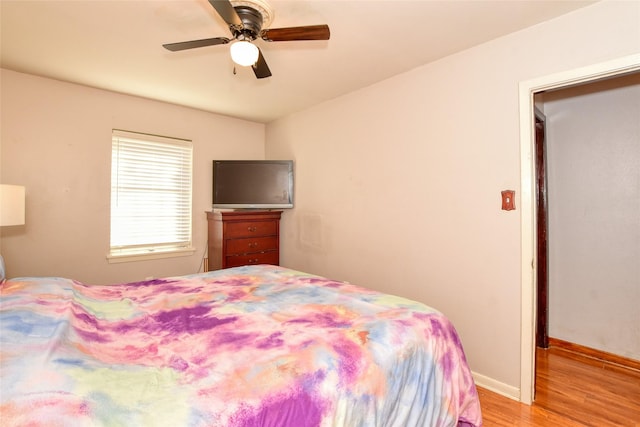 bedroom with ceiling fan and light hardwood / wood-style floors