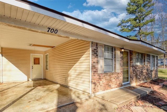 entrance to property featuring a patio