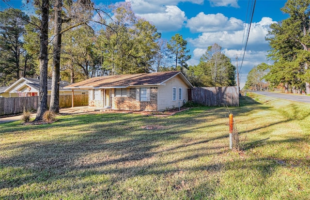 ranch-style home with a front lawn