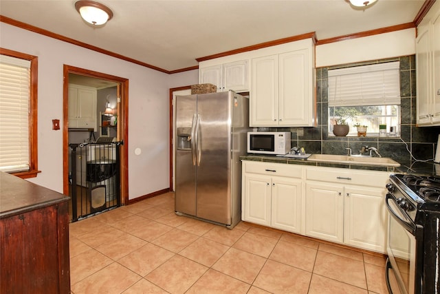 kitchen with black stove, sink, stainless steel fridge with ice dispenser, white cabinetry, and light tile patterned flooring