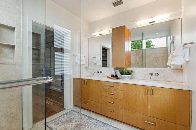 bathroom featuring tile patterned floors, vanity, and an enclosed shower