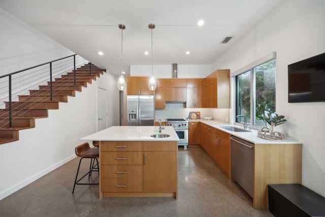 kitchen featuring pendant lighting, a kitchen island, sink, and appliances with stainless steel finishes