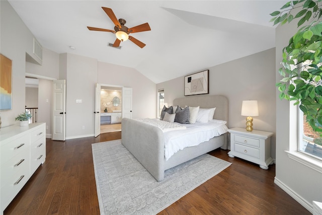 bedroom featuring ceiling fan, dark hardwood / wood-style flooring, lofted ceiling, and ensuite bath