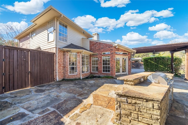 back of house with french doors, exterior kitchen, and a patio