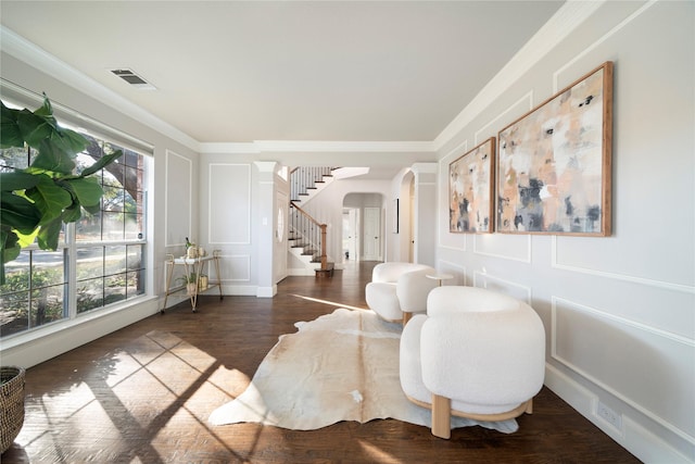 living room featuring dark hardwood / wood-style floors and crown molding