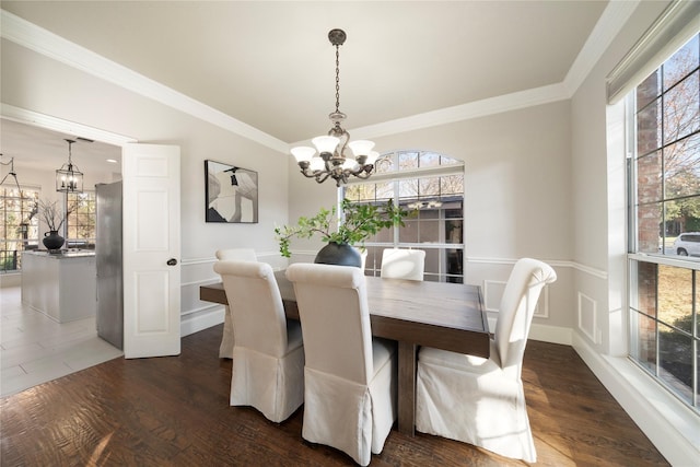 dining room with a chandelier, dark hardwood / wood-style floors, and a healthy amount of sunlight