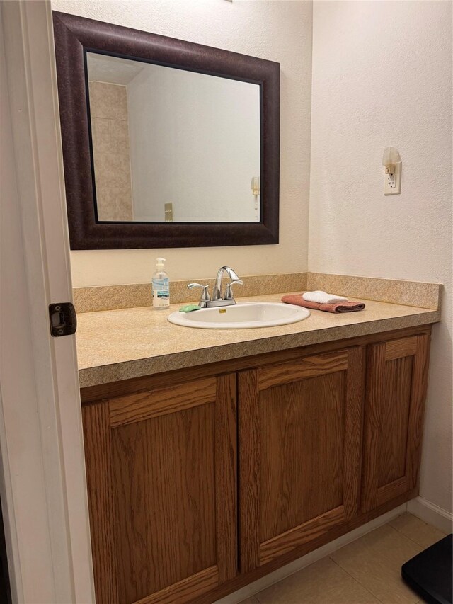 bathroom featuring tile patterned flooring and vanity