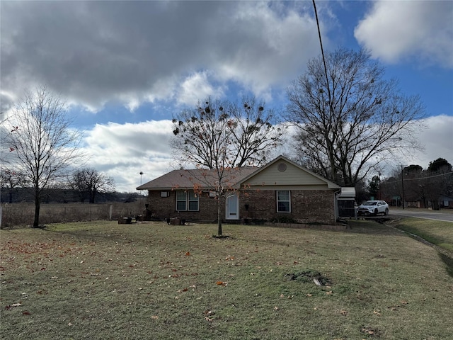 rear view of property featuring a yard