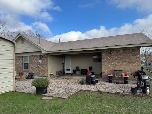 rear view of house featuring a yard and a patio