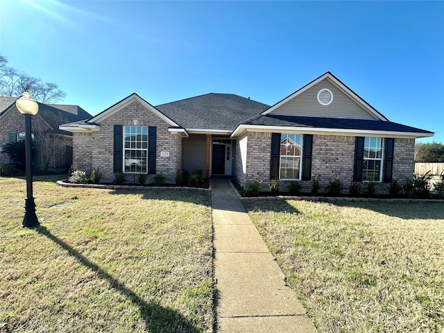 ranch-style home with a front lawn