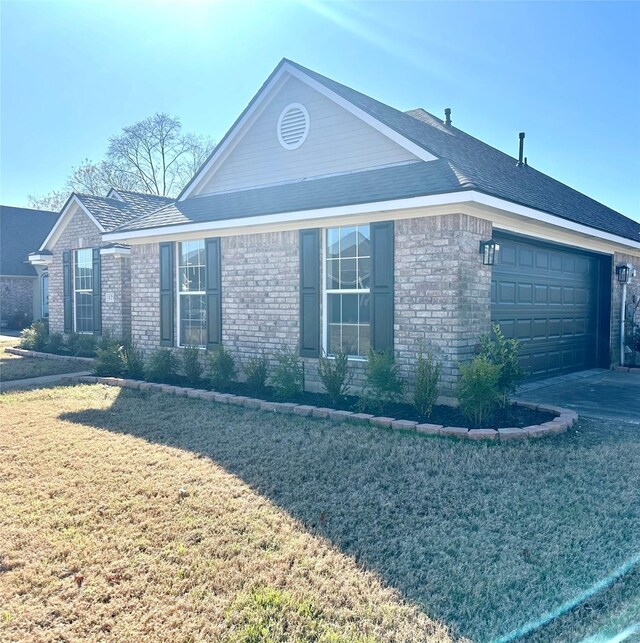 view of home's exterior featuring a yard and a garage