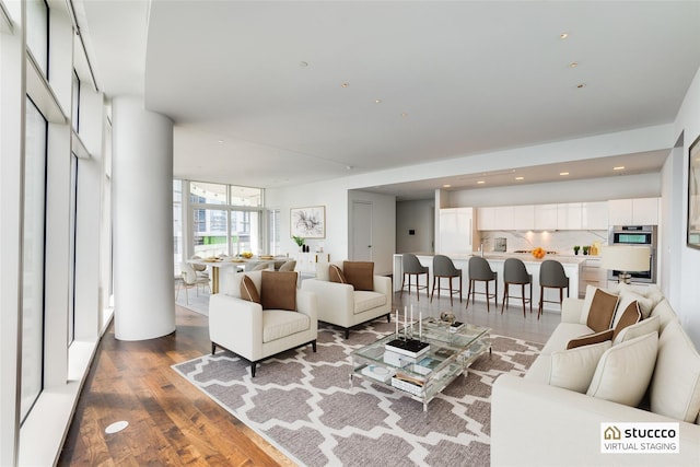 living room featuring hardwood / wood-style floors and a wall of windows