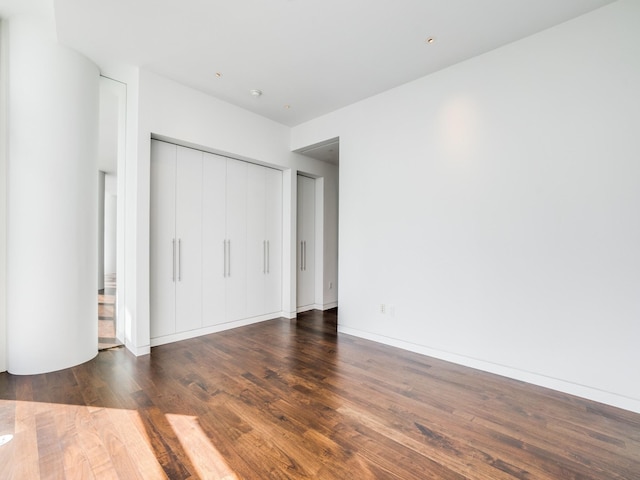 unfurnished bedroom featuring dark wood-type flooring