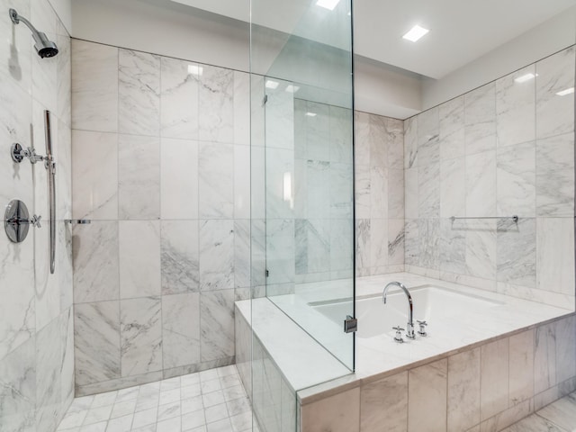 bathroom featuring shower with separate bathtub