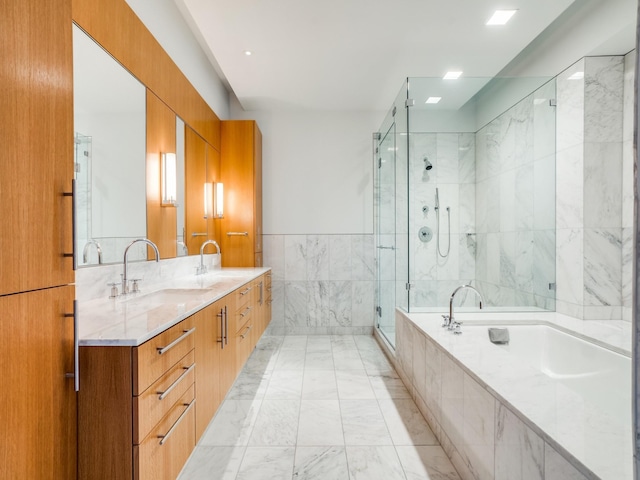 bathroom featuring vanity, tile walls, and independent shower and bath