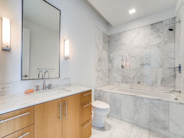 full bathroom featuring toilet, vanity, and tiled shower / bath