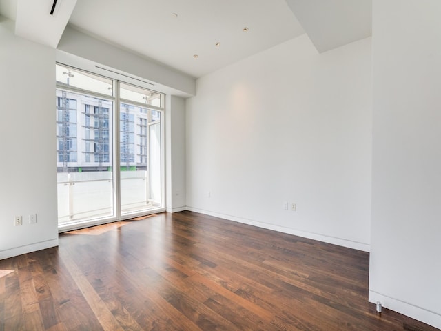 empty room with dark hardwood / wood-style floors