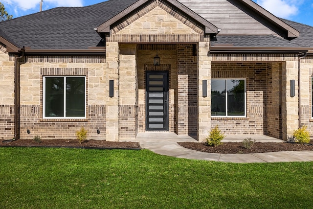 doorway to property with a yard