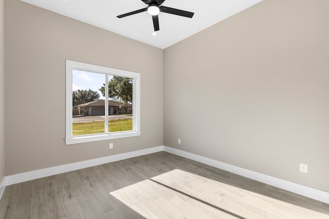 spare room with light wood-type flooring and ceiling fan