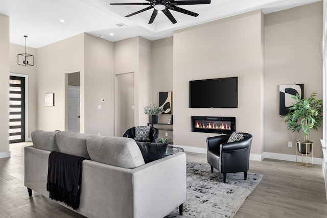 living room with wood-type flooring and ceiling fan