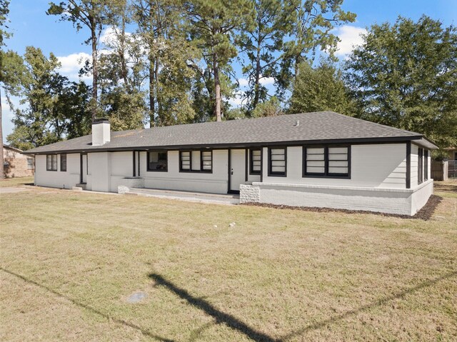 ranch-style house with a front lawn