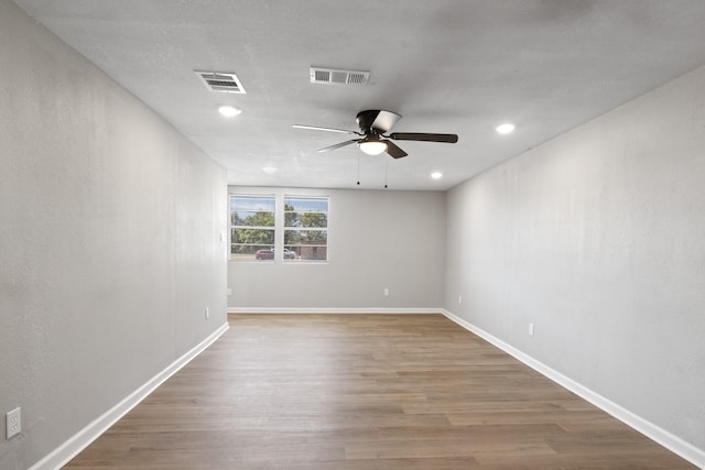 spare room featuring hardwood / wood-style floors and ceiling fan