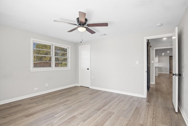 spare room featuring ceiling fan and light hardwood / wood-style floors