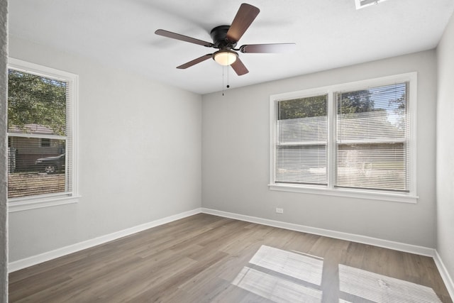 empty room featuring hardwood / wood-style flooring and ceiling fan