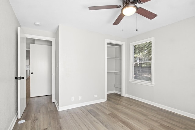 unfurnished bedroom featuring a closet, light hardwood / wood-style flooring, and ceiling fan