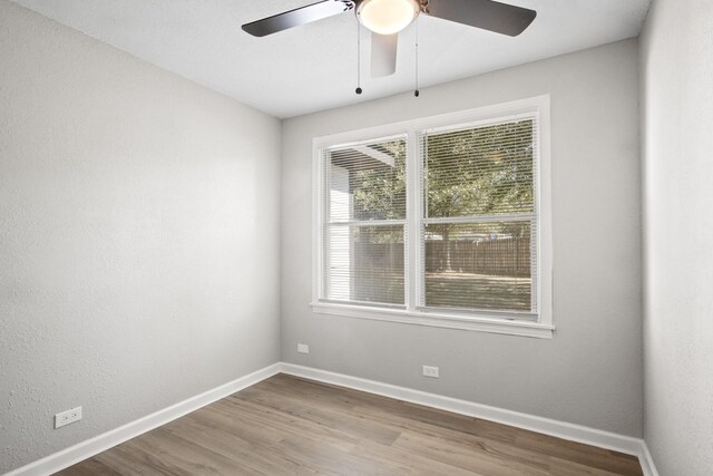 unfurnished room with hardwood / wood-style floors and ceiling fan