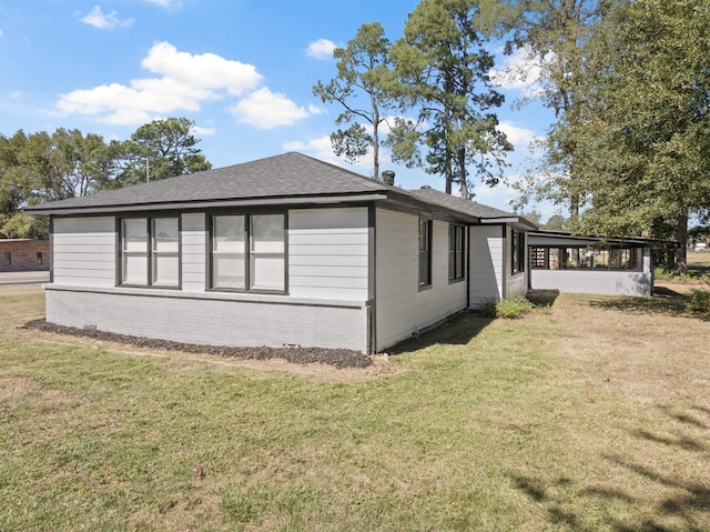 view of side of property with a yard