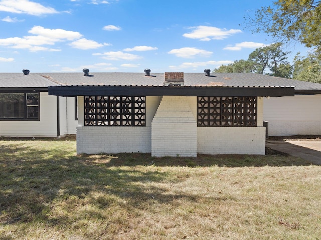 view of side of home with a lawn