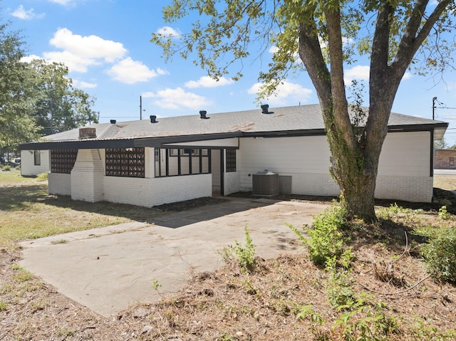 rear view of property with a patio area, a sunroom, and cooling unit