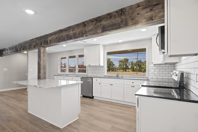 kitchen featuring stainless steel dishwasher, electric range, a kitchen island, light stone counters, and white cabinetry